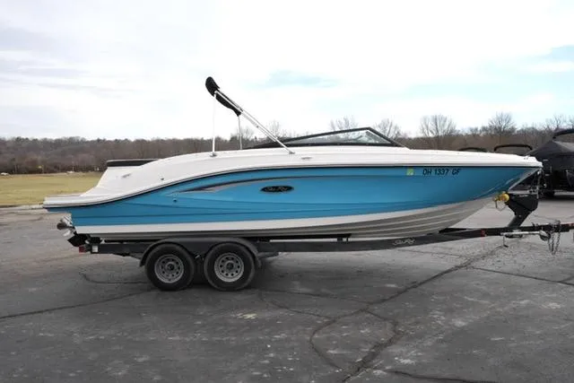 Slide: The Image of 2021 Sea Ray SPX 230 boat on trailer, blue and white design, parked outdoors. - 5