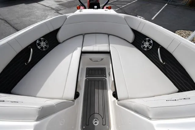 Slide: The Image of 2021 Sea Ray SPX 230 boat interior with white cushioned seating and sleek design. - 7