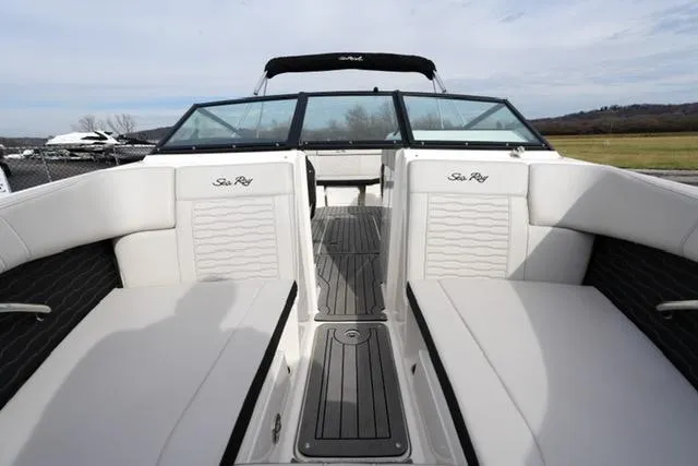 Slide: The Image of 2021 Sea Ray SPX 230 boat interior with white seating and sleek design. - 8