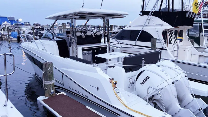Slide: The Image of 2022 Jeanneau Leader 10.5 WA S2 boat docked with Yamaha engines. - 1