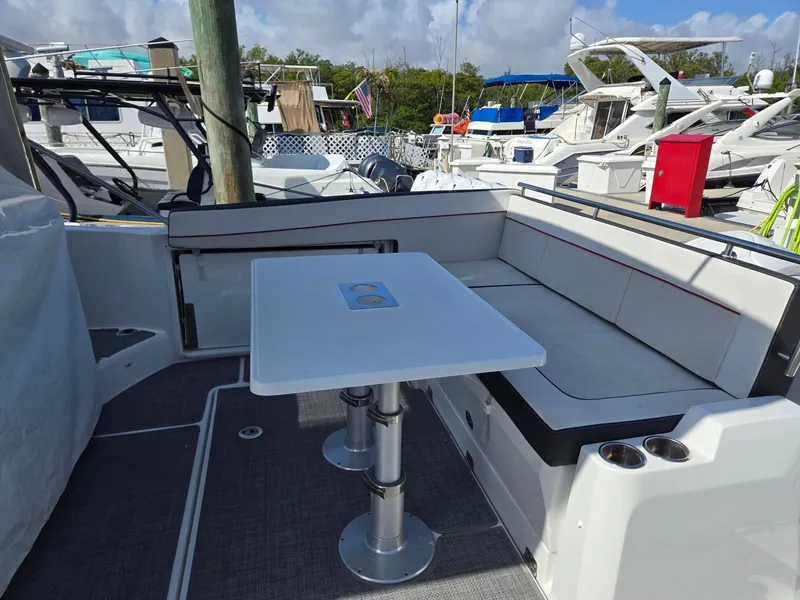 Slide: The Image of 2022 Jeanneau Leader 10.5 WA S2 boat with seating and table on deck. - 6