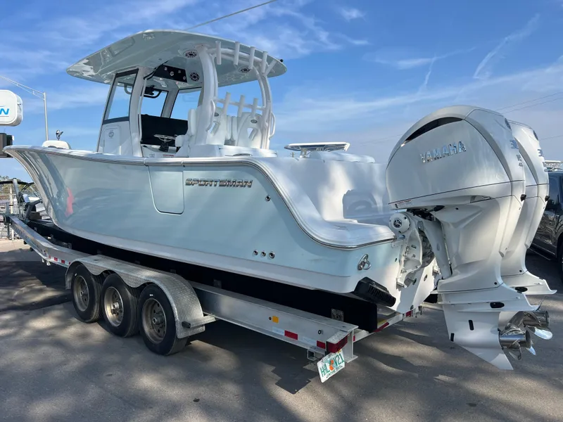 Slide: The Image of 2025 Sportsman Open 302 Center Console boat on trailer with dual engines. - 4