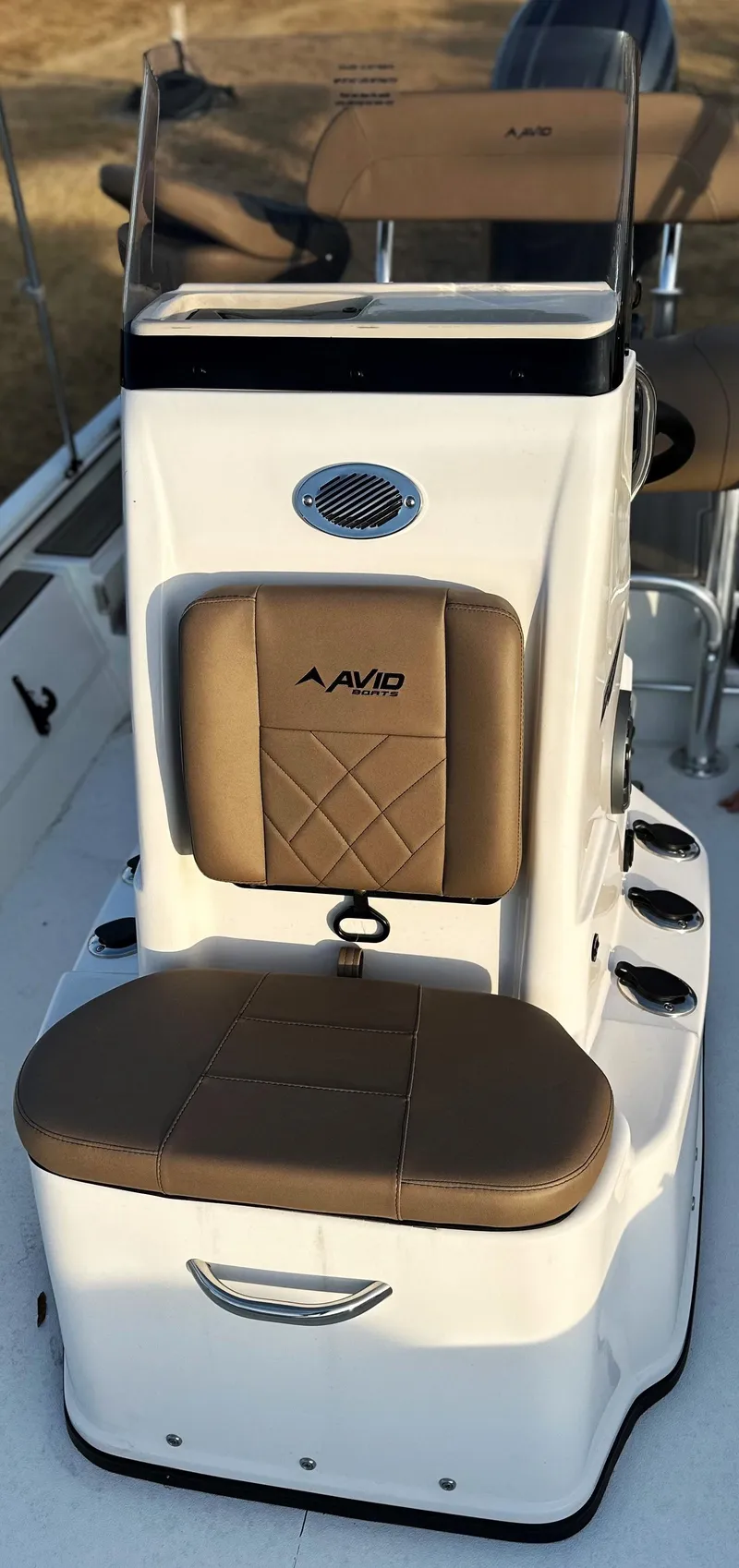 Slide: The Image of 2025 Avid Rogue 20 CC boat console with brown cushioned seating. - 10