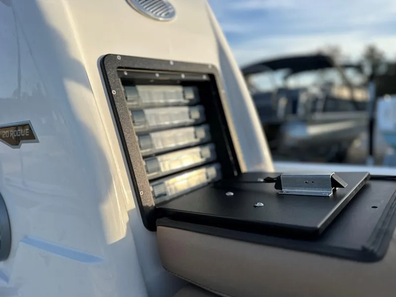 Slide: The Image of 2025 Avid Rogue 20 CC boat detail with open storage compartment. - 13