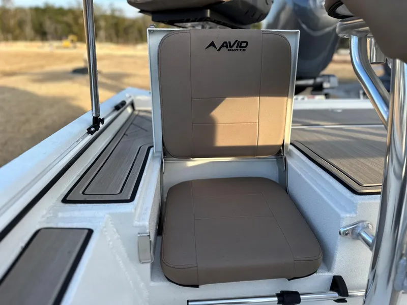 Slide: The Image of 2025 Avid Rogue 20 CC boat seat with brown cushion and logo. - 4