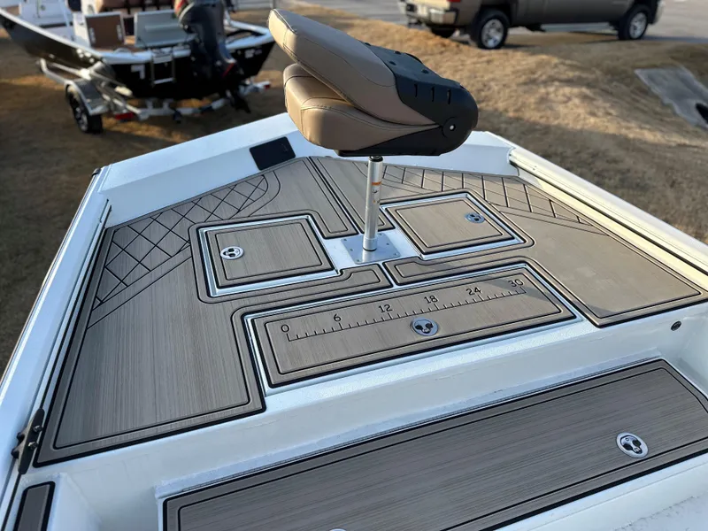 Slide: The Image of 2025 Avid Rogue 20 CC boat deck with seating and storage compartments. - 6