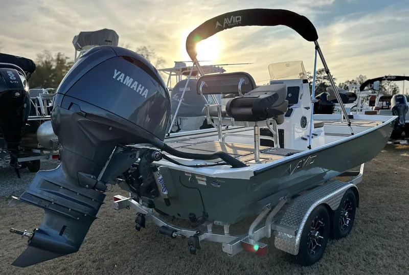 Slide: The Image of 2025 Avid Rogue 20 CC boat with Yamaha engine, parked on a trailer at sunset. - 8