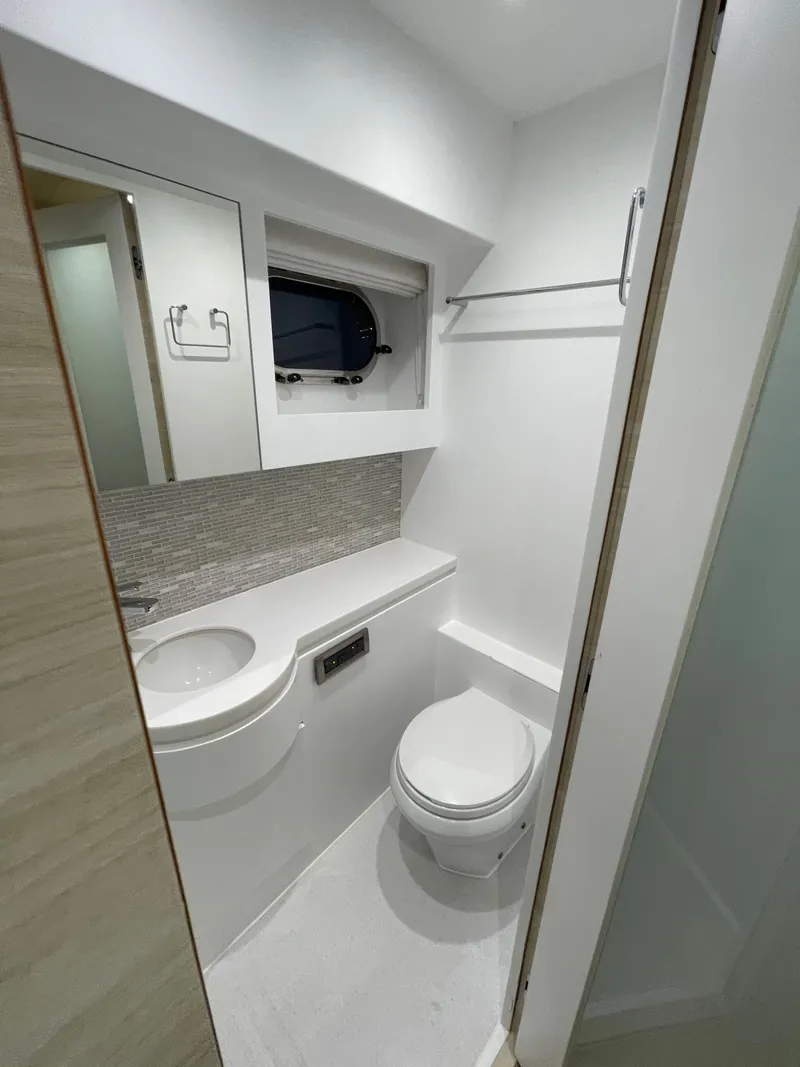 Slide: The Image of Compact modern bathroom in 2017 Horizon PC60 yacht, featuring sleek fixtures and minimalist design. - 12