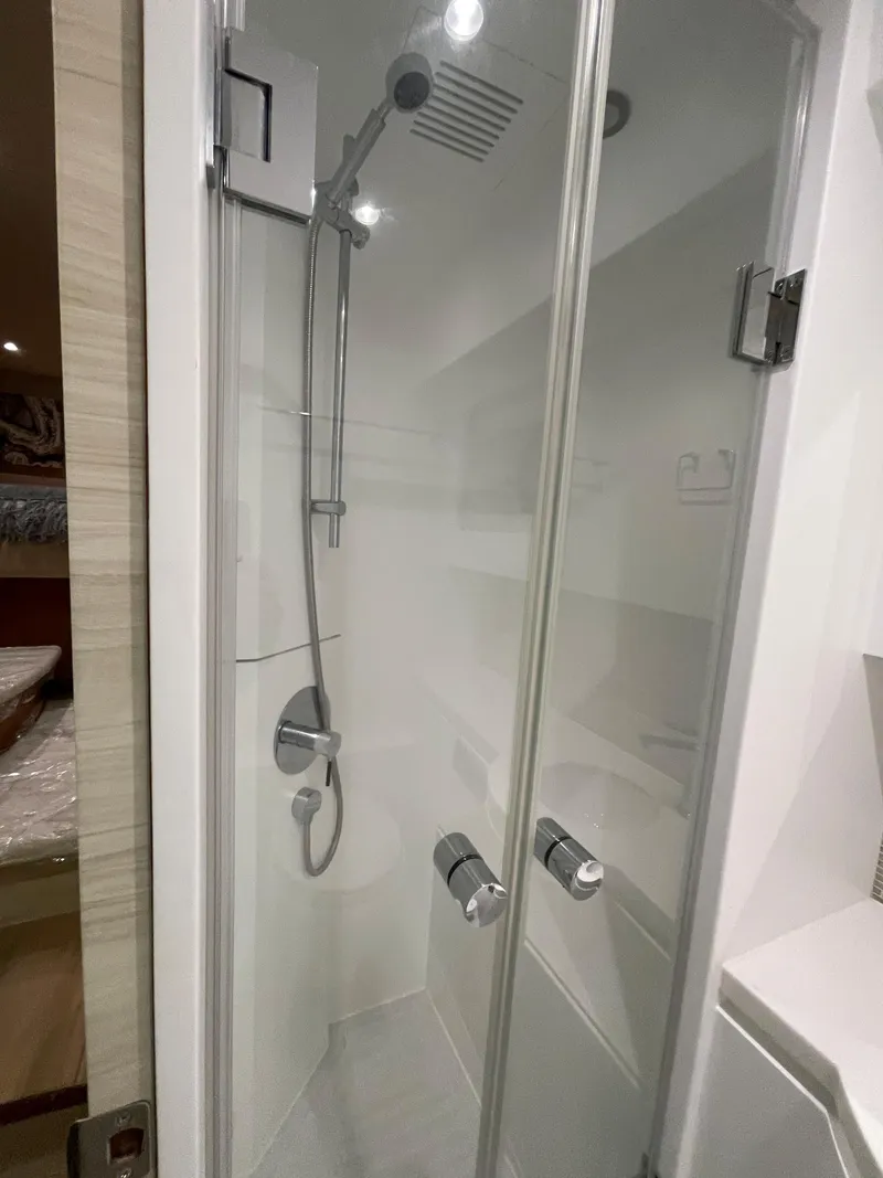Slide: The Image of Modern shower cabin in 2017 Horizon PC60 yacht, featuring sleek glass doors and chrome fixtures. - 16