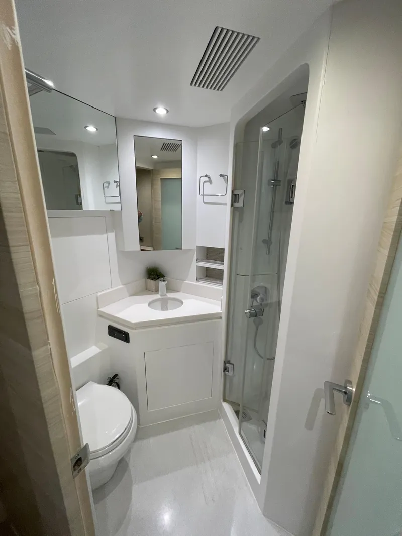 Slide: The Image of Compact modern bathroom in 2017 Horizon PC60 yacht, featuring shower, toilet, and sink. - 17