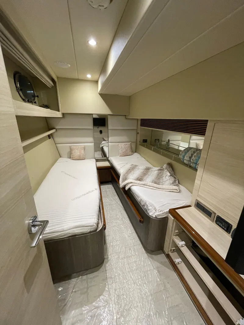 Slide: The Image of 2017 Horizon PC60 yacht cabin with twin beds and modern interior design. - 18
