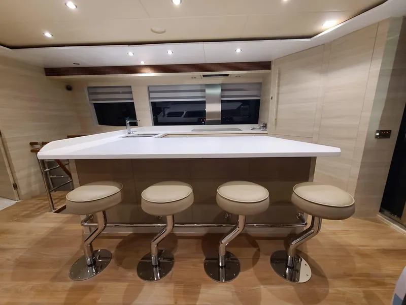 Slide: The Image of Luxurious yacht interior with modern bar stools and sleek design, Horizon PC60, 2017 model. - 5