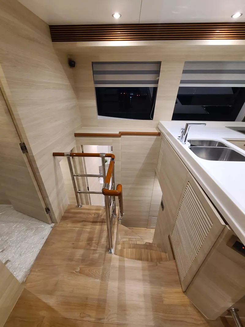 Slide: The Image of Modern yacht interior with wooden stairs, sleek kitchen, and large windows. Horizon PC60, 2017 model. - 9