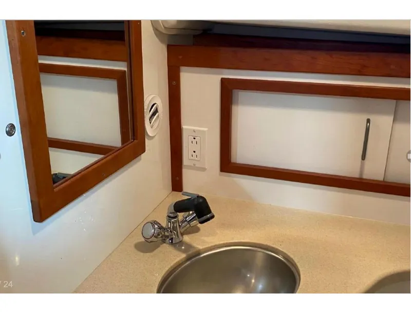 Slide: The Image of 2006 Back Cove 29 boat interior with sink and wooden accents. - 11