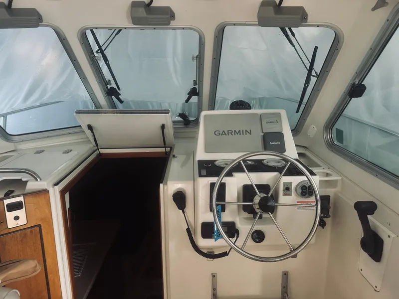 Slide: The Image of 2006 Back Cove 29 boat interior with Garmin navigation system and steering wheel. - 19