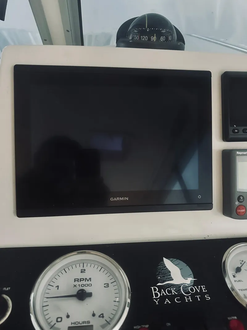 Slide: The Image of Dashboard of a 2006 Back Cove 29 yacht with Garmin display and gauges. - 21