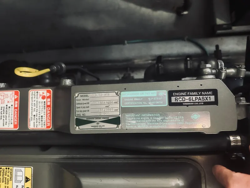 Slide: The Image of Engine compartment of a 2006 Back Cove 29 boat, showing model and safety labels. - 23