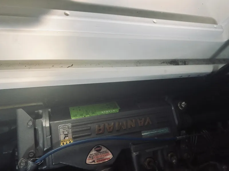 Slide: The Image of Engine compartment of a 2006 Back Cove 29 boat featuring a Yanmar engine. - 25