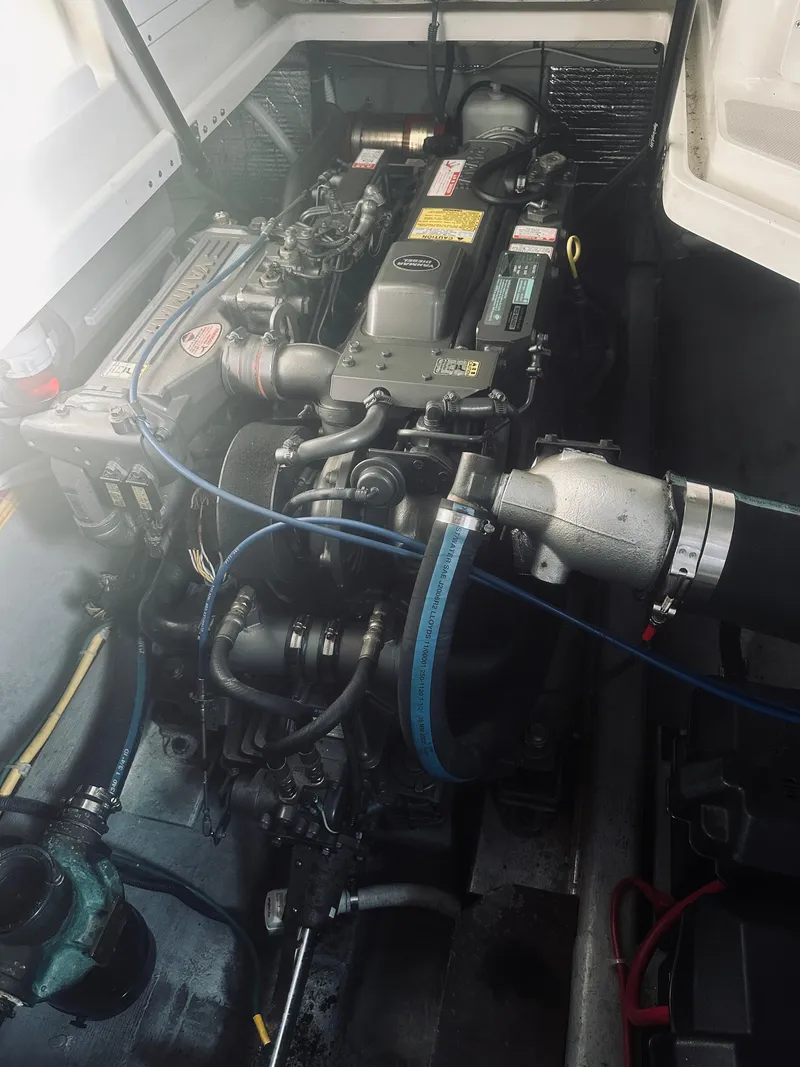 Slide: The Image of Engine compartment of a 2006 Back Cove 29 boat, showcasing detailed mechanical components. - 26