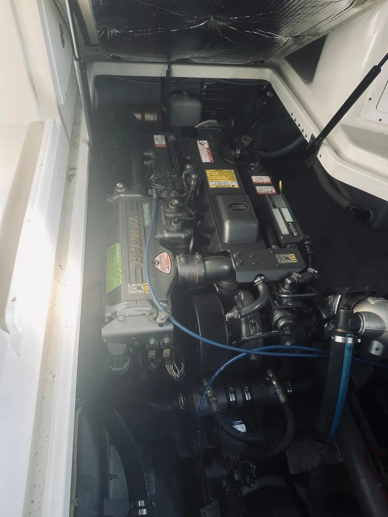 Slide: The Image of Engine compartment of a 2006 Back Cove 29 boat, showcasing mechanical components. - 27