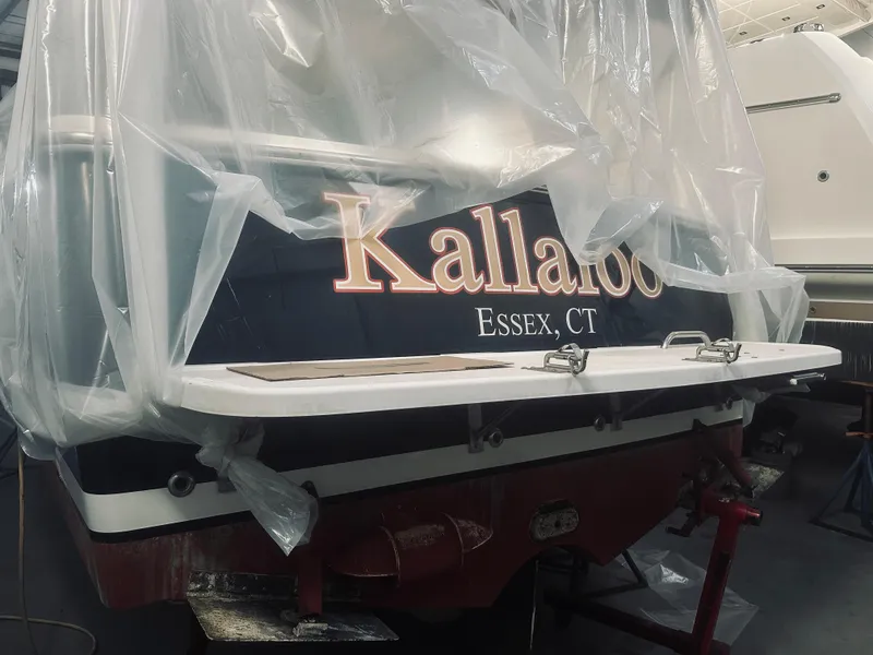 Slide: The Image of 2006 Back Cove 29 boat named "Kallaloo" in Essex, CT, covered in protective plastic. - 31