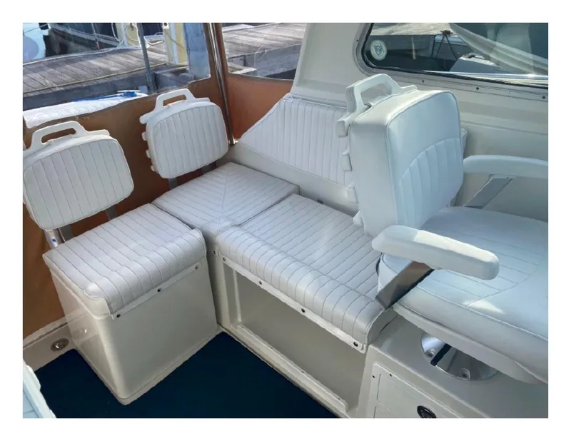 Slide: The Image of 2006 Back Cove 29 boat interior with white cushioned seating. - 6
