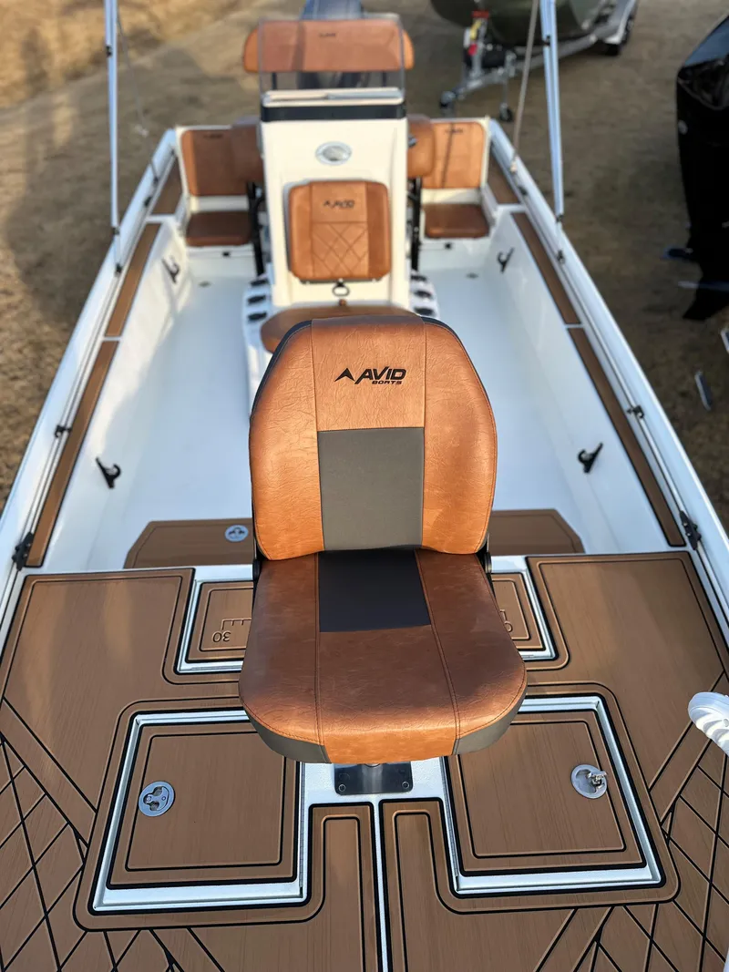 Slide: The Image of 2025 Avid Rogue 20 CC boat interior with brown leather seating and modern design. - 10