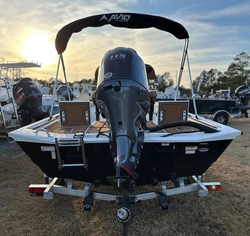 Slide: The Image of Avid Rogue 20 CC 2025 boat with outboard motor at sunset. - 14