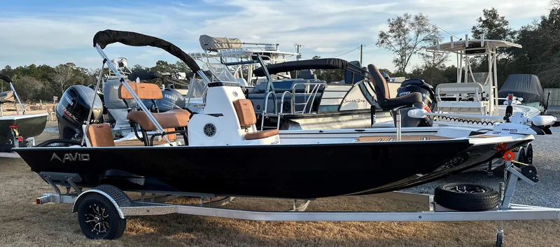 Slide: The Image of 2025 Avid Rogue 20 CC boat on trailer, sleek design, black hull, outdoor display. - 17