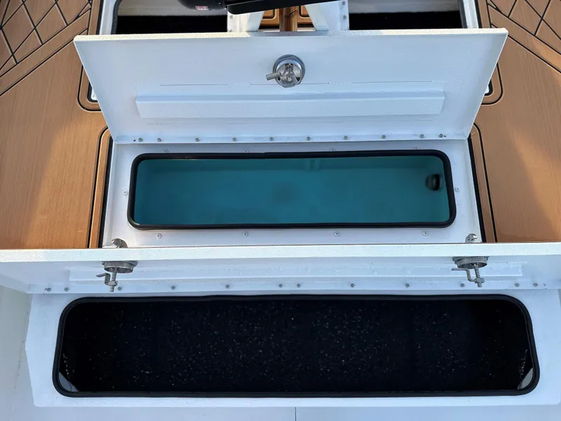 Slide: The Image of 2025 Avid Rogue 20 CC boat storage compartments, open view. - 3