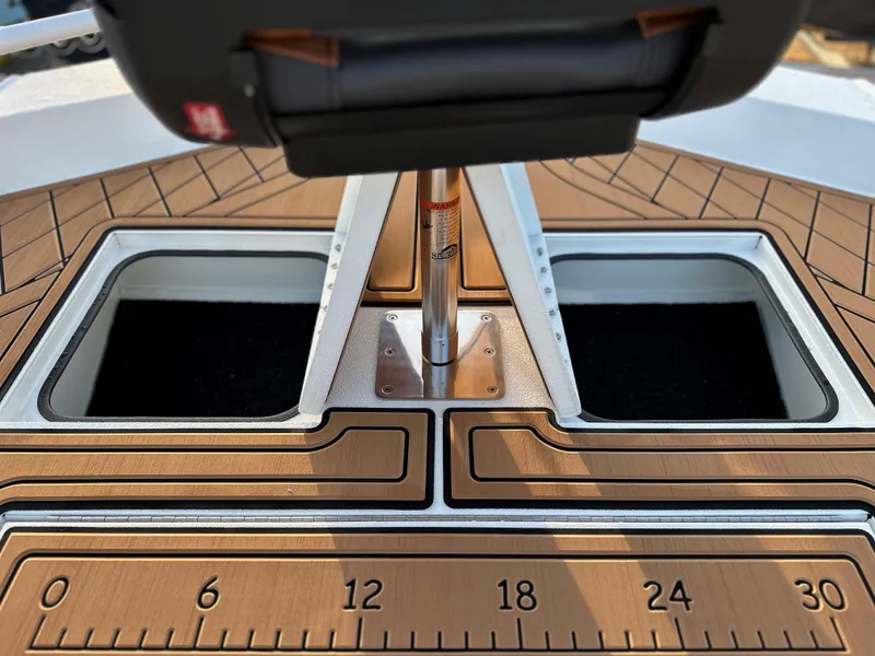 Slide: The Image of 2025 Avid Rogue 20 CC boat deck with storage compartments and measuring scale. - 4