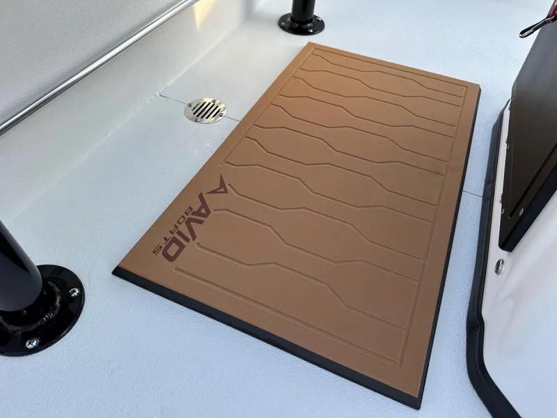 Slide: The Image of Avid Rogue 20 CC 2025 boat deck with brown non-slip mat and drainage. - 9