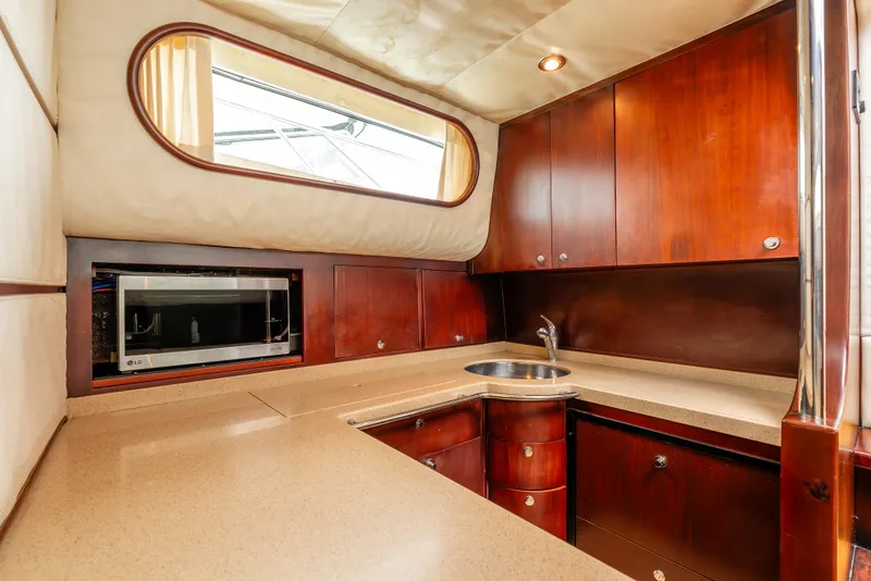 Slide: The Image of Luxurious interior of 2006 Chris-Craft Roamer 40 yacht with wood finishes and modern amenities. - 16