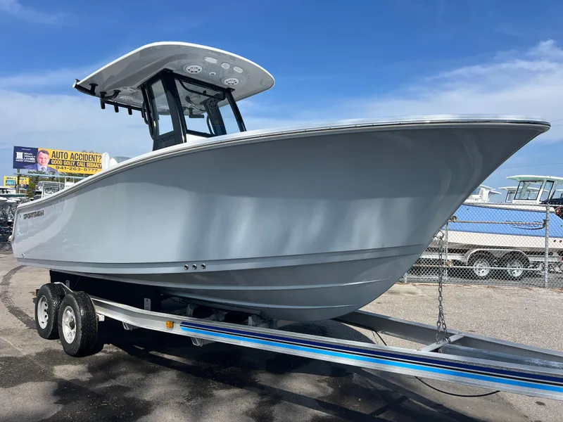 The Image of 2025 Sportsman Open 212 Center Console boat on trailer, parked outdoors under blue sky. - 0