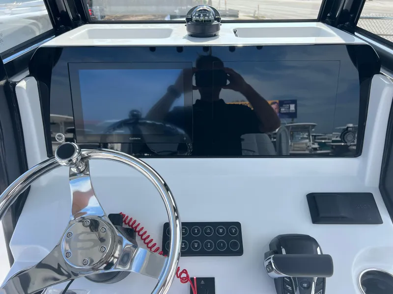 Slide: The Image of 2025 Sportsman Open 212 Center Console dashboard with steering wheel and control panel. - 12