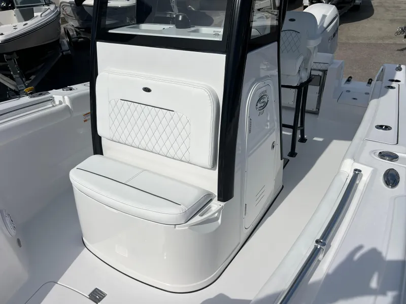 Slide: The Image of 2025 Sportsman Open 212 Center Console boat interior with white seating and console. - 16
