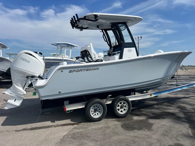 Slide: The Image of 2025 Sportsman Open 212 Center Console boat on trailer, parked outdoors. - 3
