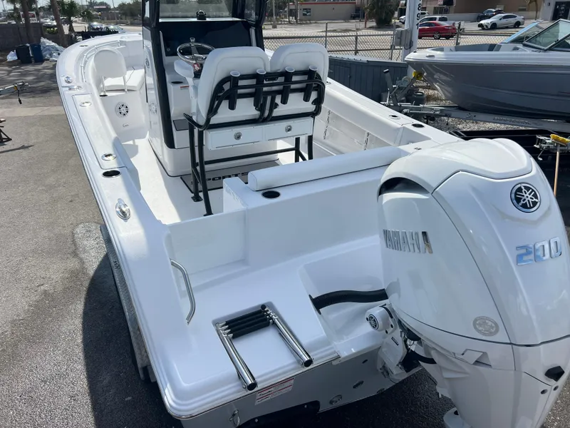 Slide: The Image of 2025 Sportsman Open 212 Center Console boat with Yamaha 200 engine, docked outdoors. - 7