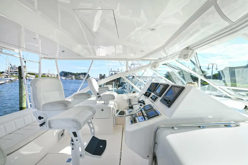 Slide: The Image of 2007 Cabo 40 Express with Tower, fishing rods stored overhead, docked at marina. - 13