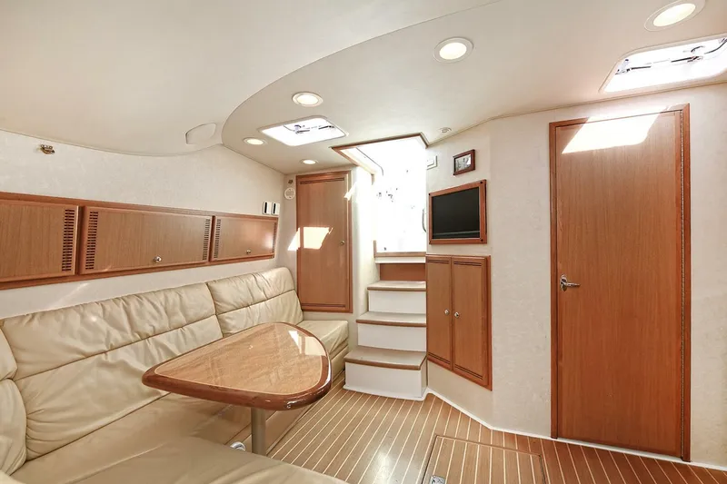 Slide: The Image of Luxurious interior of 2007 Cabo 40 Express yacht with leather seating and wooden cabinetry. - 16