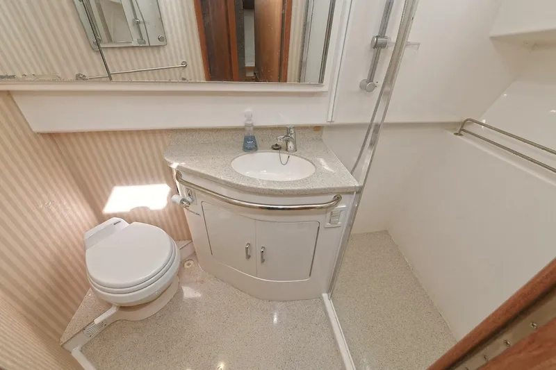 Slide: The Image of Luxurious interior of 2007 Cabo 40 Express yacht with wooden cabinetry and leather seating. - 20