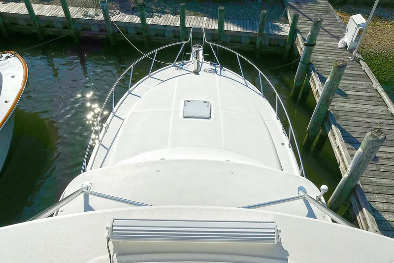 Slide: The Image of 2007 Cabo 40 Express boat helm with navigation equipment and scenic dock view. - 30