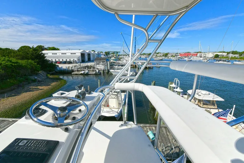 Slide: The Image of 2007 Cabo 40 Express with Tower, showcasing sleek design and metal framework against blue sky. - 32