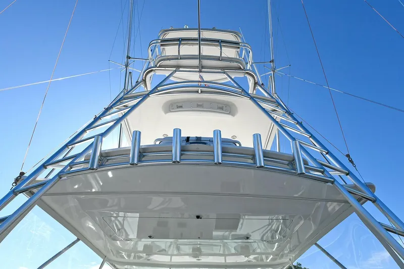Slide: The Image of 2007 Cabo 40 Express boat deck with fishing rod holders and storage compartments. - 34