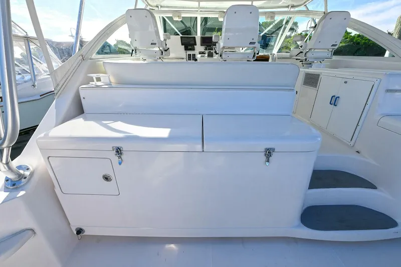 Slide: The Image of 2007 Cabo 40 Express with Tower, spacious white interior, helm chairs, and clear canopy. - 8