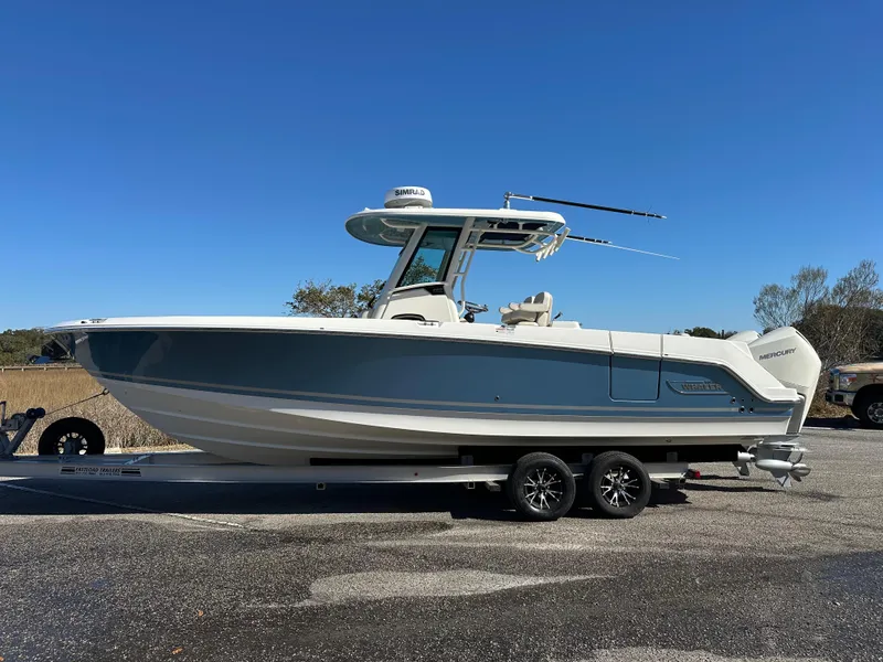 Slide: The Image of 2023 Boston Whaler 280 Outrage boat on trailer, side view, clear sky background. - 10