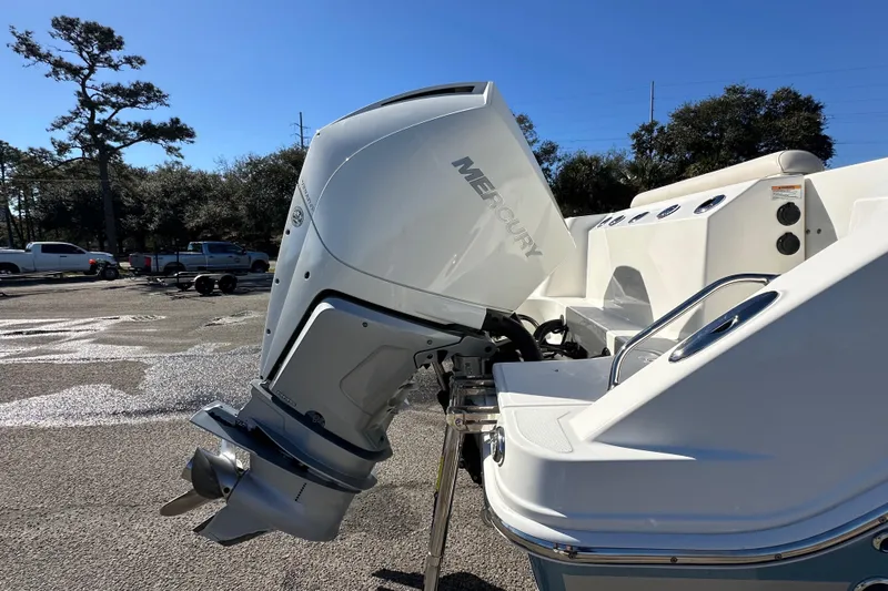 Slide: The Image of 2023 Boston Whaler 280 Outrage with Mercury outboard engine in a parking lot. - 14