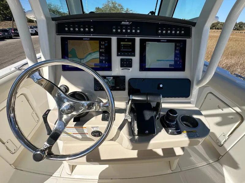 Slide: The Image of 2023 Boston Whaler 280 Outrage helm with advanced navigation displays and controls. - 17