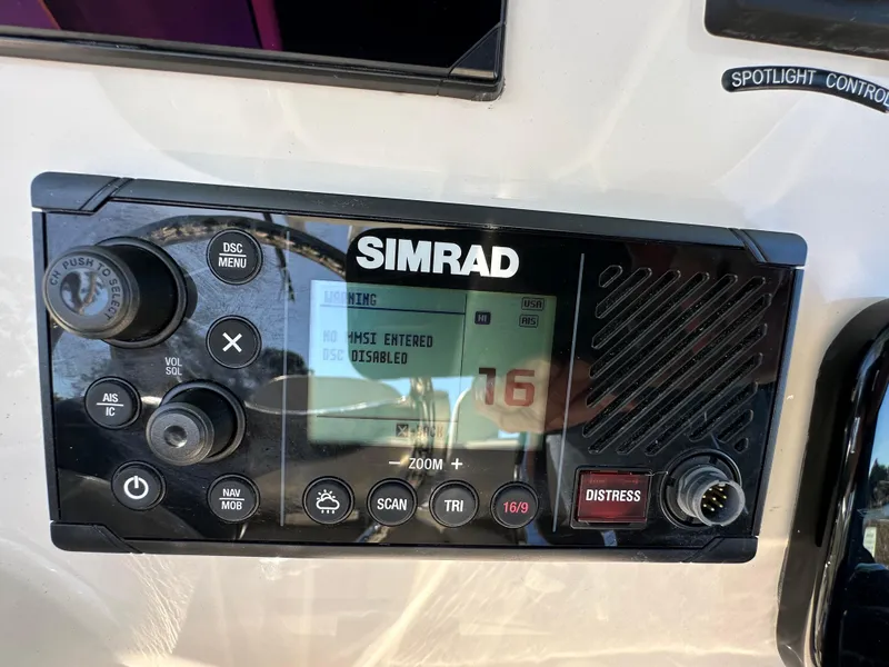Slide: The Image of Simrad marine radio on 2023 Boston Whaler 280 Outrage boat dashboard. - 21