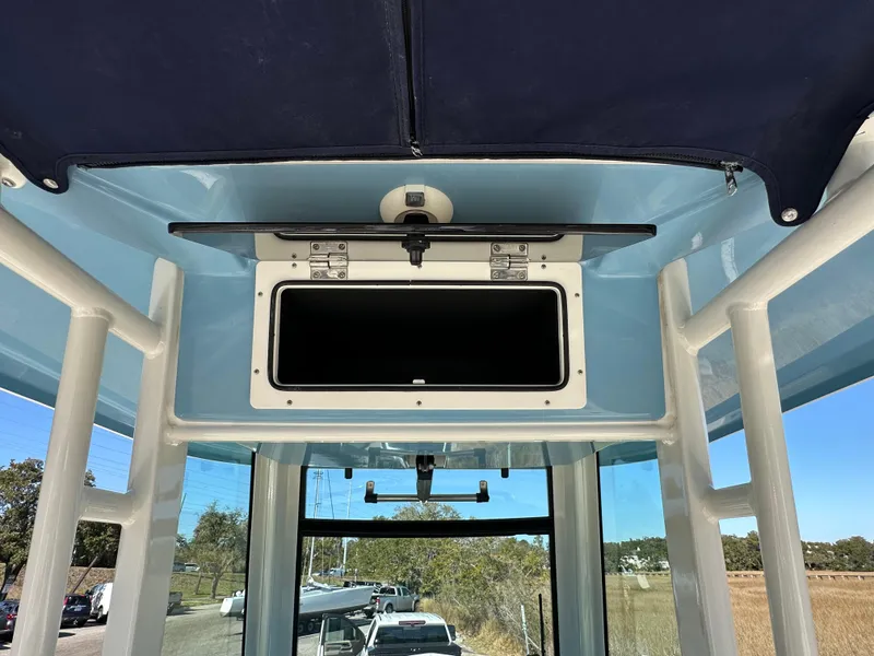 Slide: The Image of 2023 Boston Whaler 280 Outrage boat interior, featuring a storage compartment and overhead view. - 25